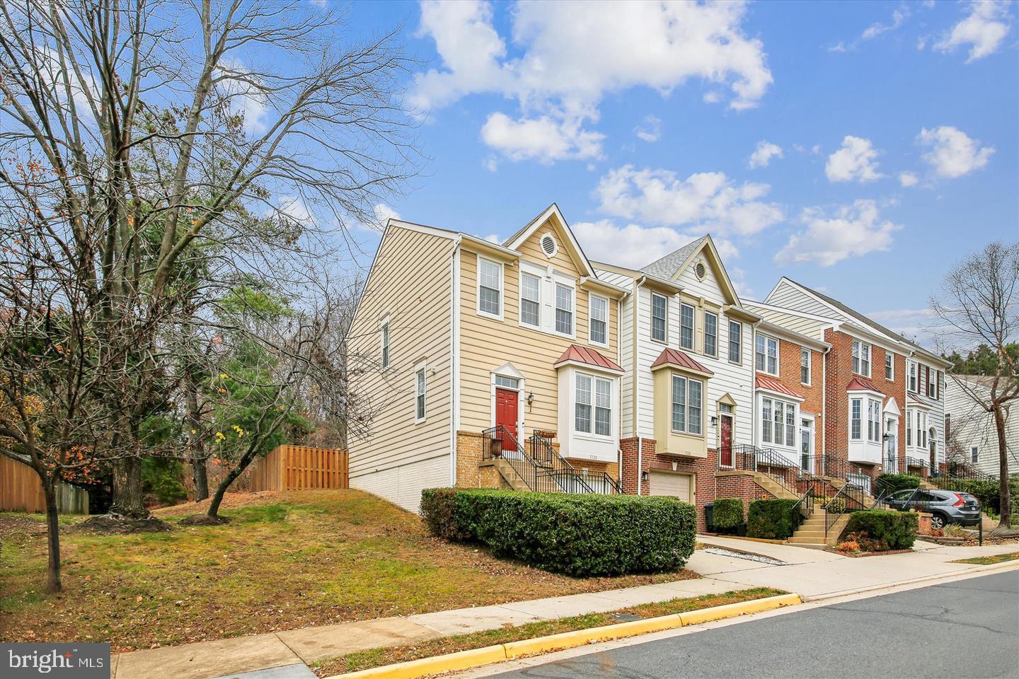 7728 Hickory Glen Way Springfield, VA 22153 - Photo 3 of 35 a front view of a residential apartment building with a yard