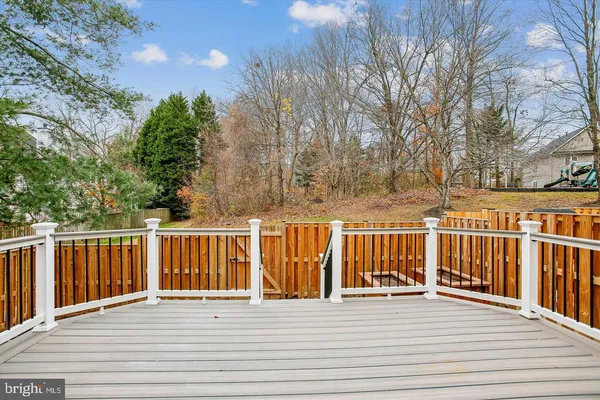 a view of a balcony with wooden floor and fence