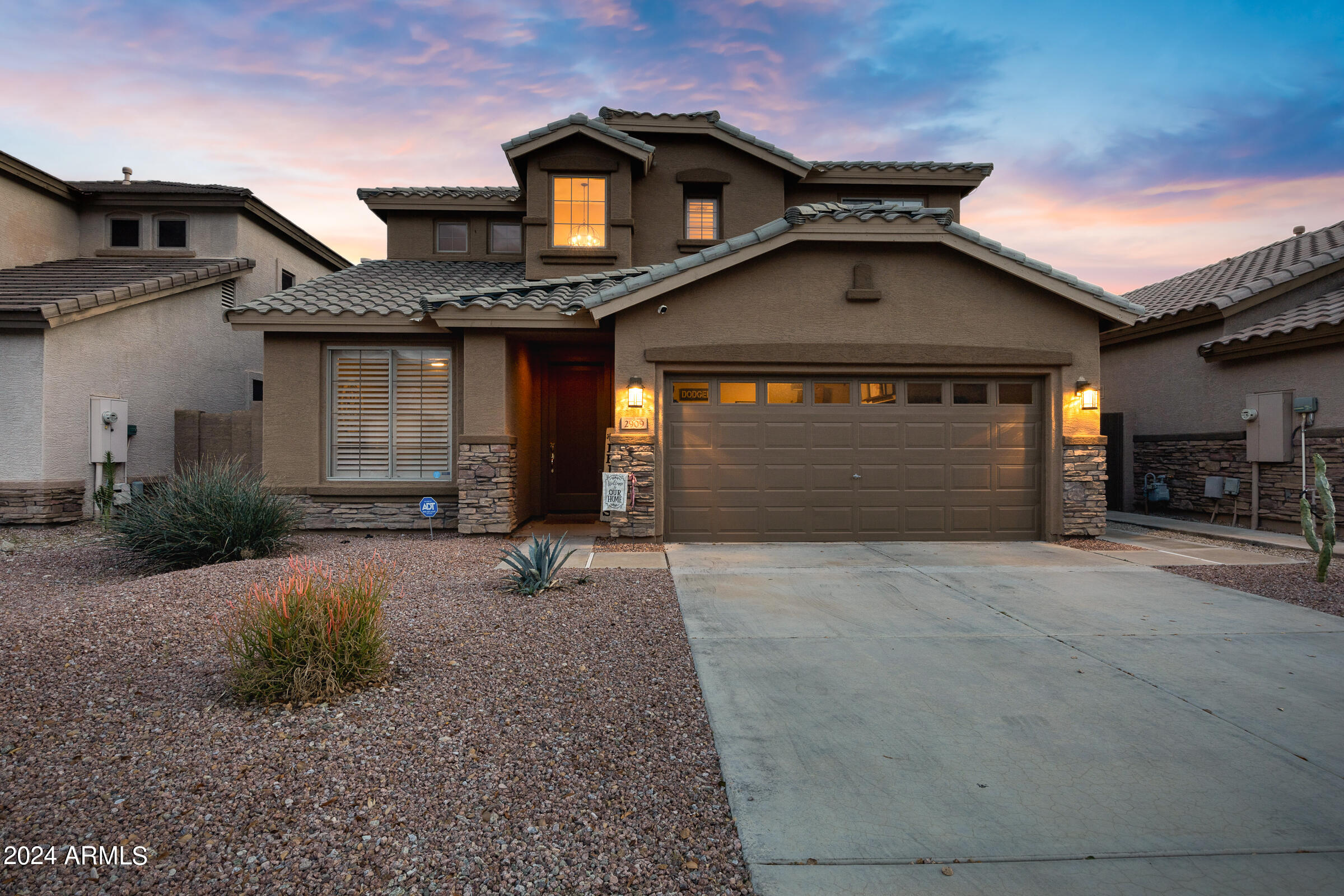 2909 West Silver Fox Way Phoenix, AZ 85045 - Photo 1 of 34 a front view of a house with a yard and garage