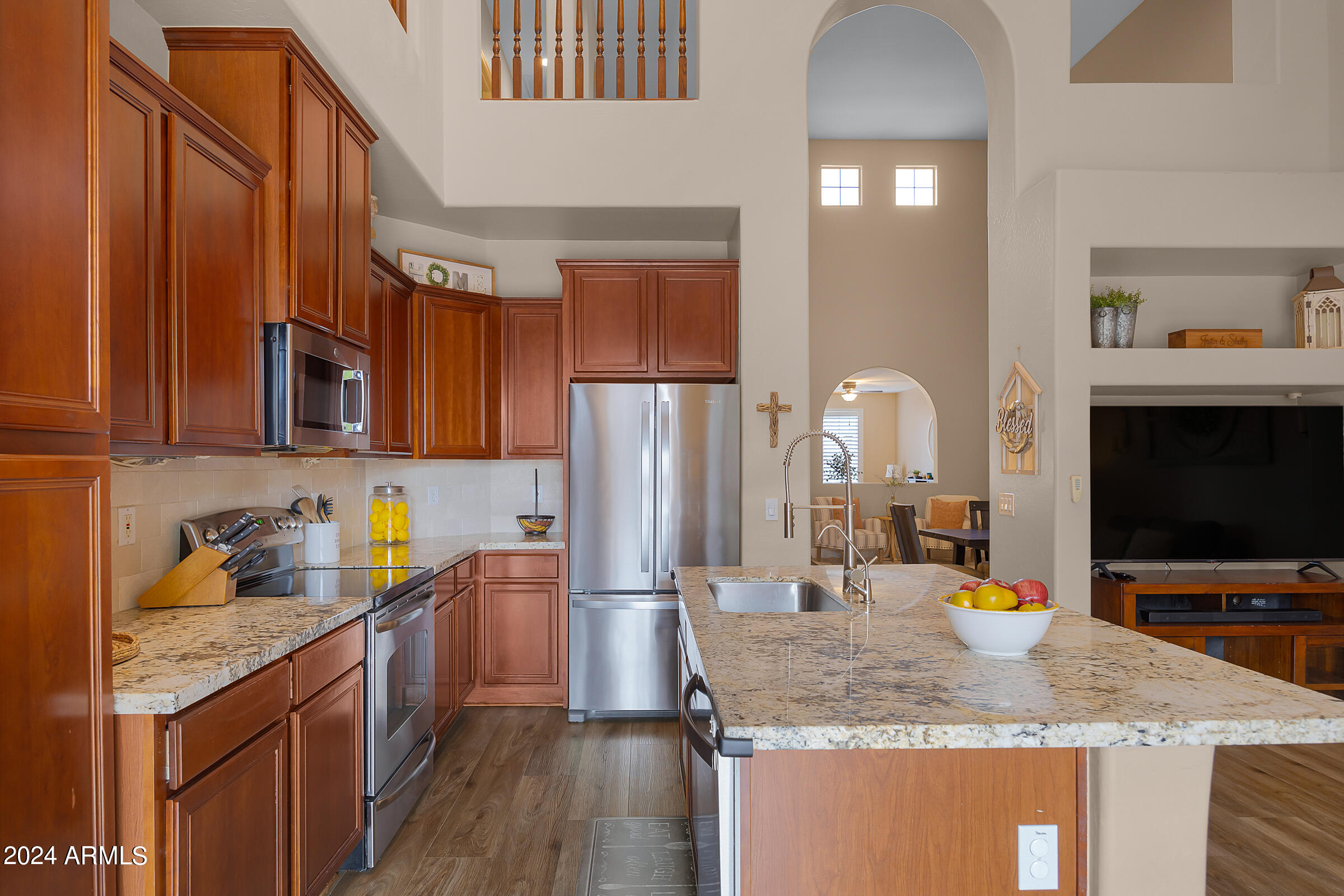 2909 West Silver Fox Way Phoenix, AZ 85045 - Photo 11 of 34 a kitchen with stainless steel appliances granite countertop a sink stove and refrigerator