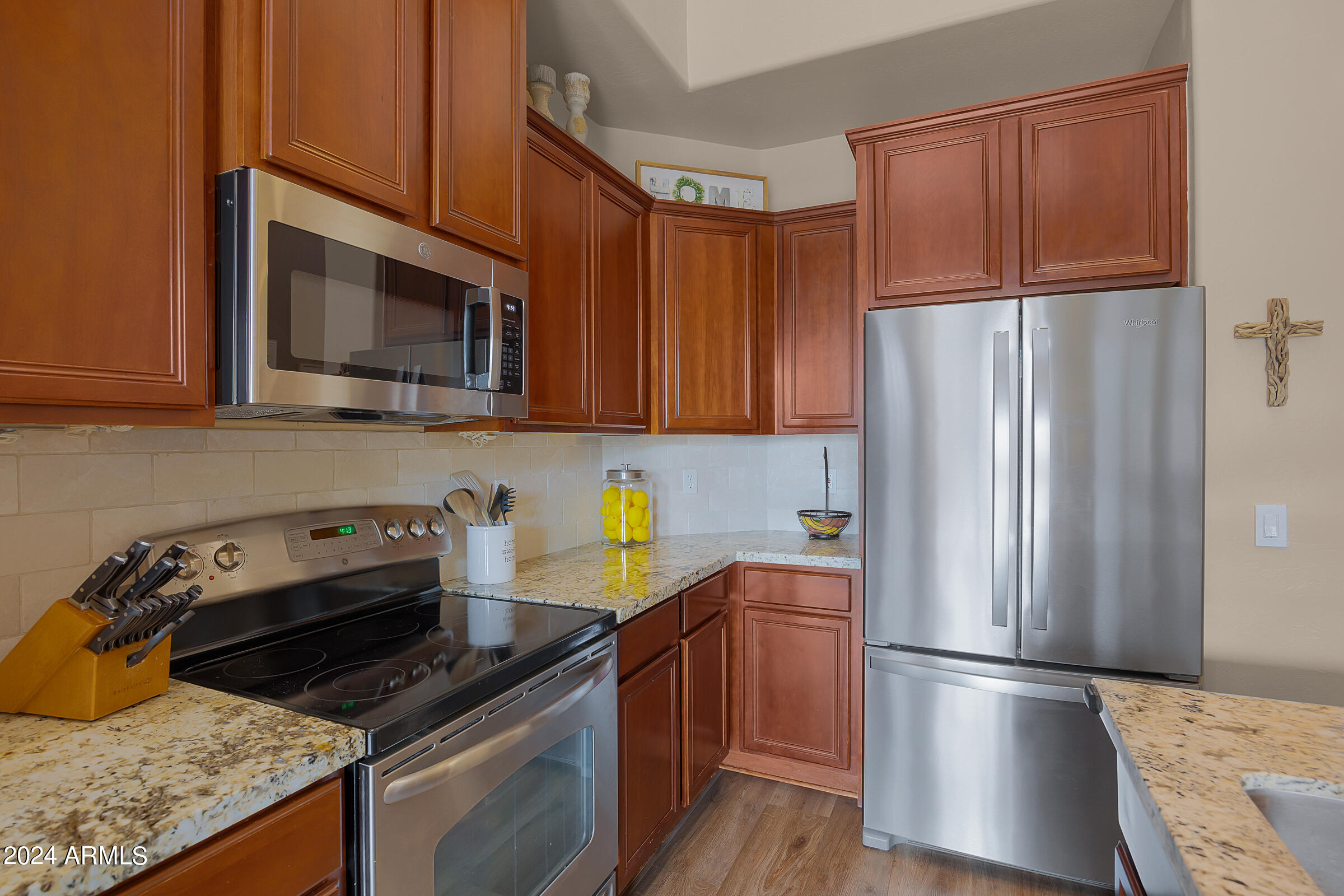 2909 West Silver Fox Way Phoenix, AZ 85045 - Photo 12 of 34 a kitchen with stainless steel appliances granite countertop a refrigerator stove and microwave