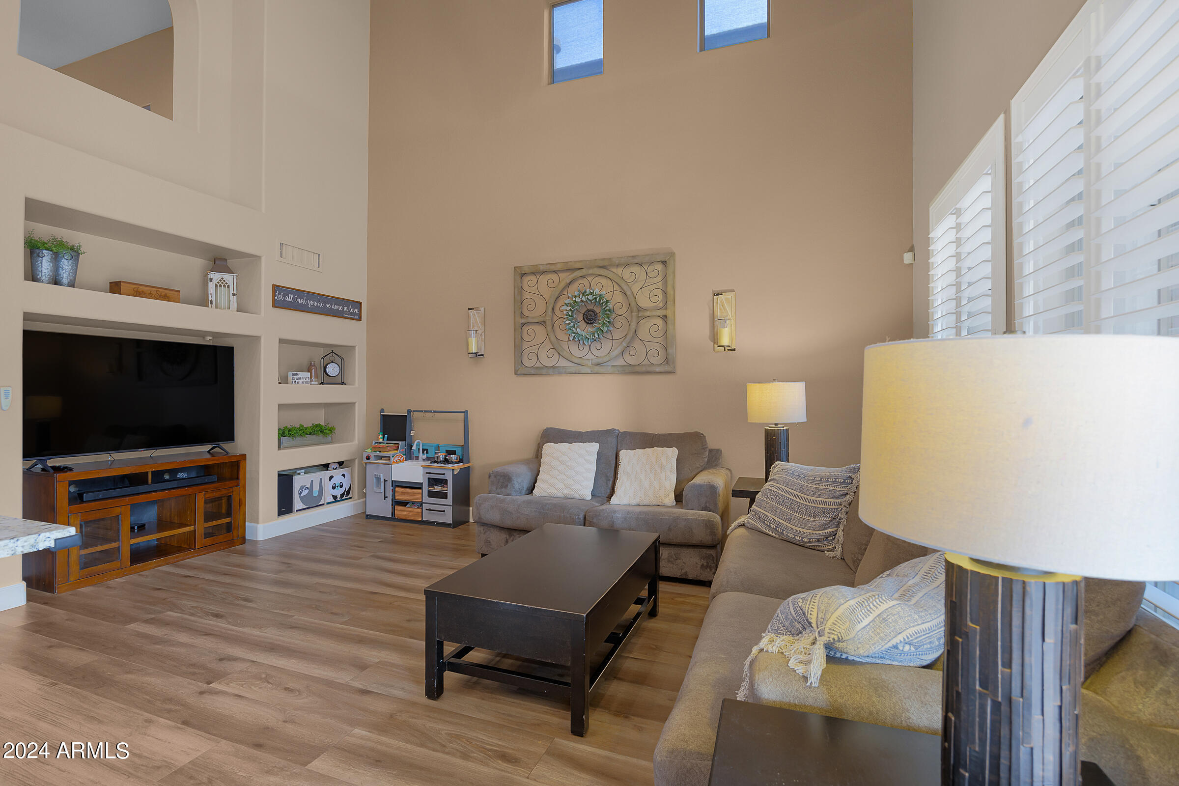 2909 West Silver Fox Way Phoenix, AZ 85045 - Photo 16 of 34 a living room with furniture and a flat screen tv