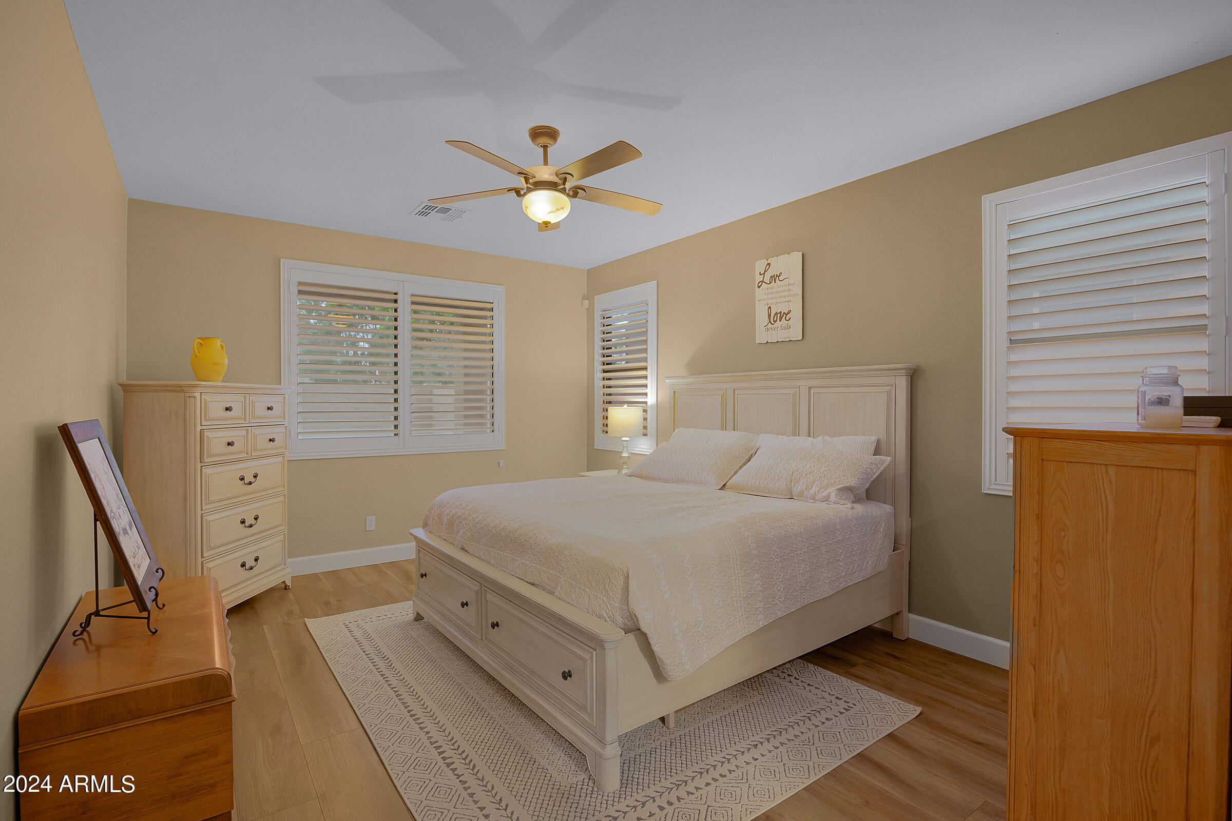 2909 West Silver Fox Way Phoenix, AZ 85045 - Photo 17 of 34 a bedroom with a bed a window and a dresser