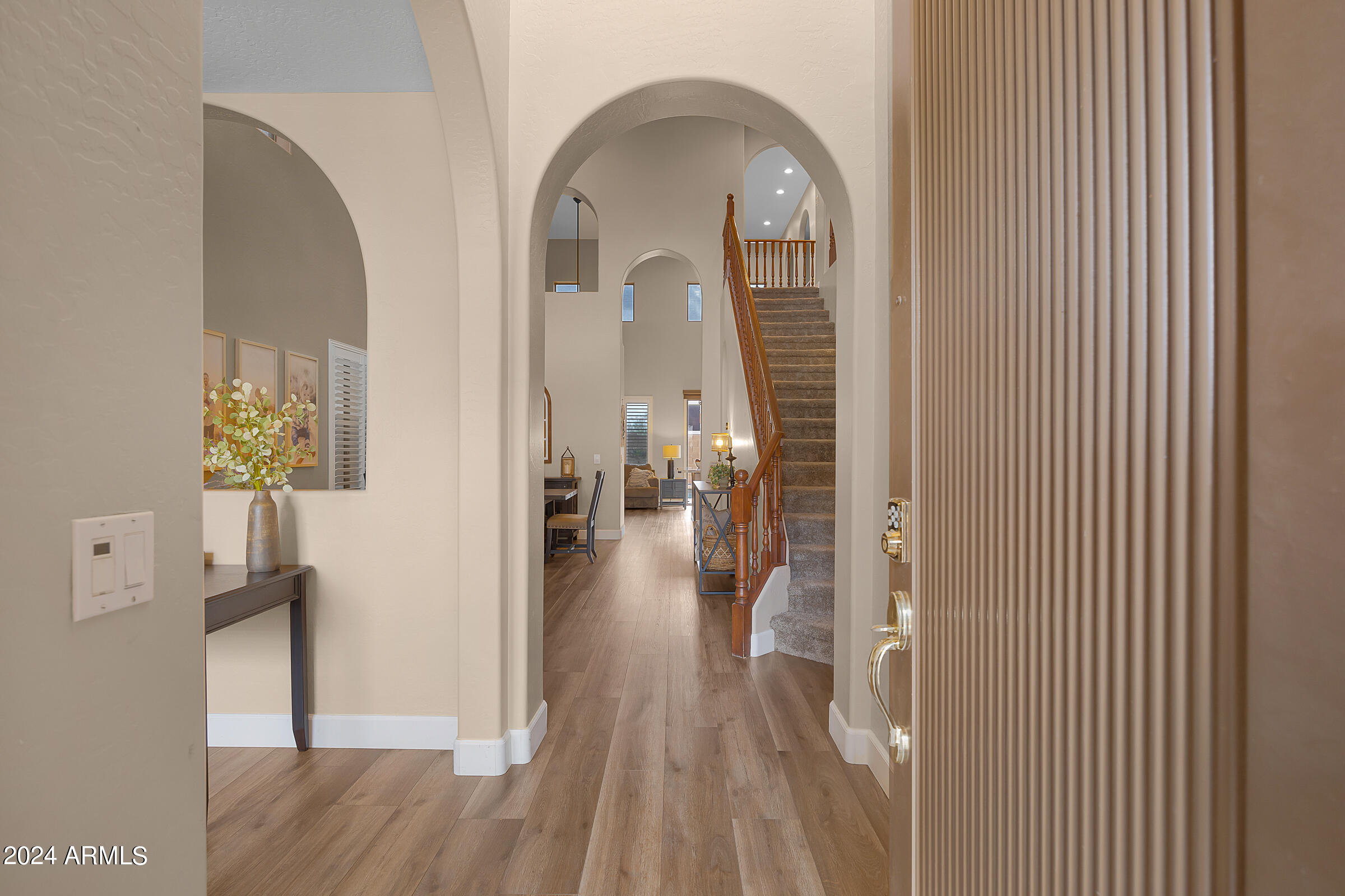 2909 West Silver Fox Way Phoenix, AZ 85045 - Photo 2 of 34 a view of a hallway with wooden floor table and chairs