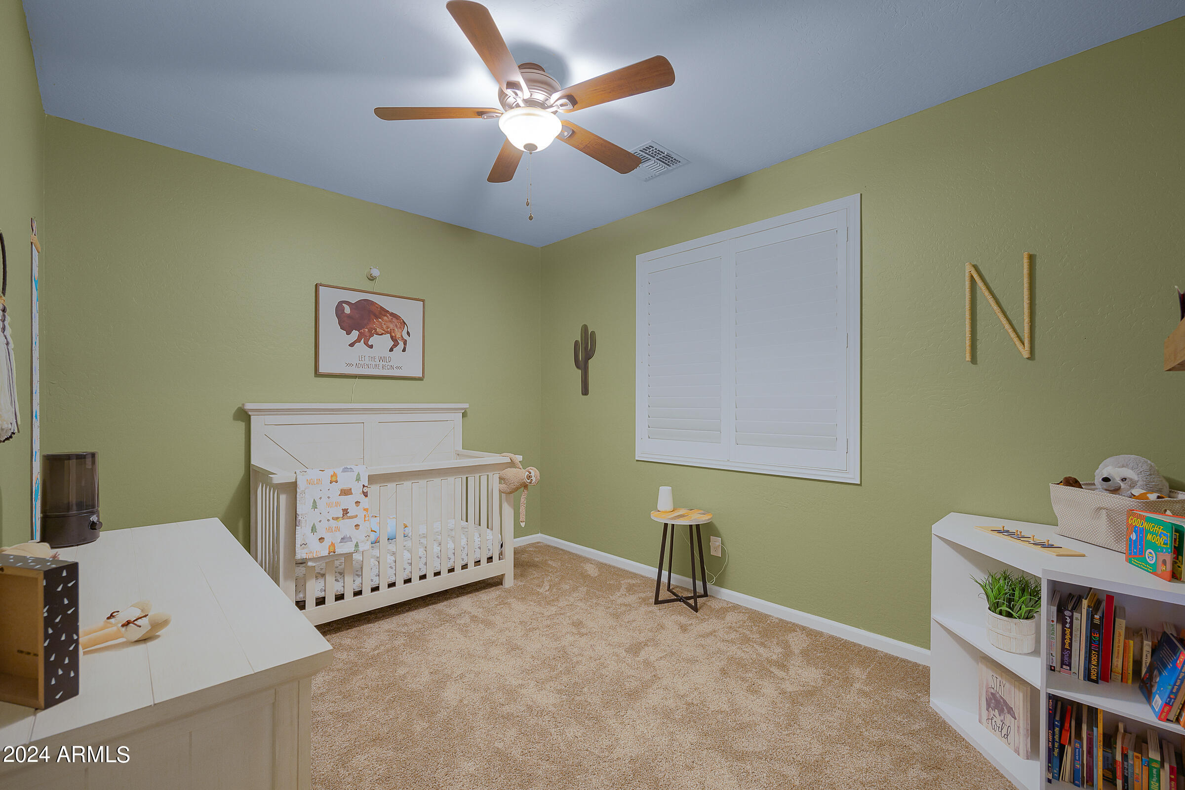 2909 West Silver Fox Way Phoenix, AZ 85045 - Photo 24 of 34 a living room with a baby crib furniture a baby crib and a book shelf