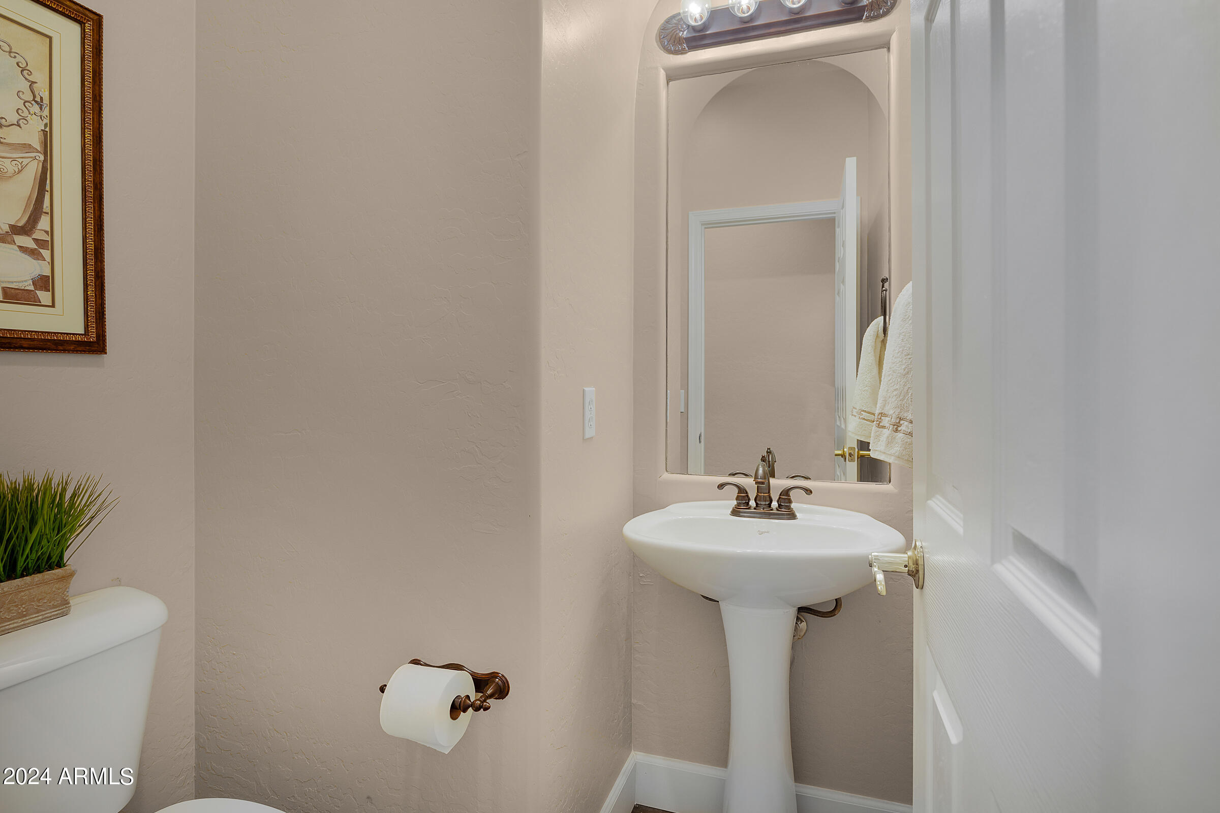 2909 West Silver Fox Way Phoenix, AZ 85045 - Photo 27 of 34 a bathroom with a sink and a mirror