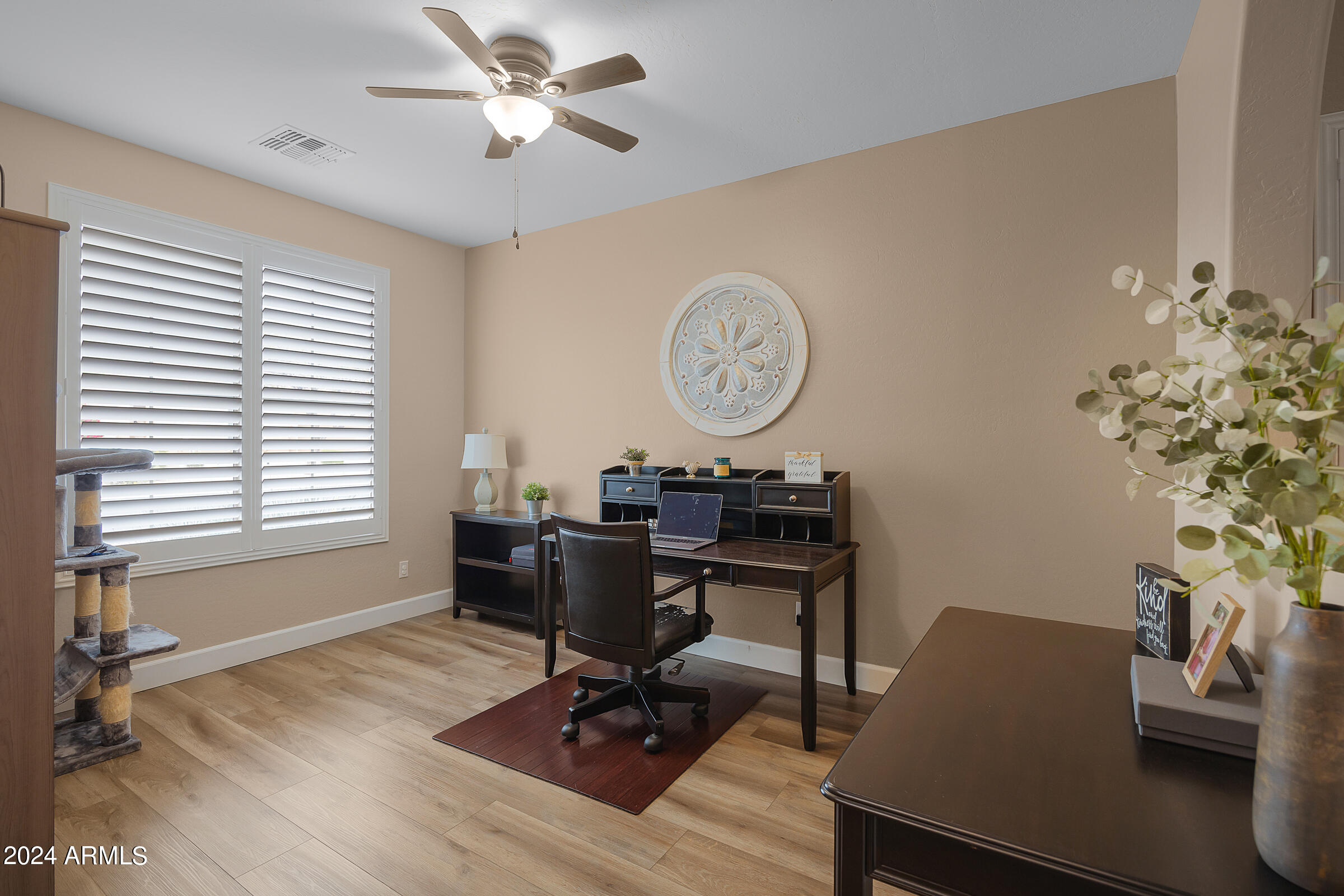 2909 West Silver Fox Way Phoenix, AZ 85045 - Photo 3 of 34 a view of a workspace with furniture and a window