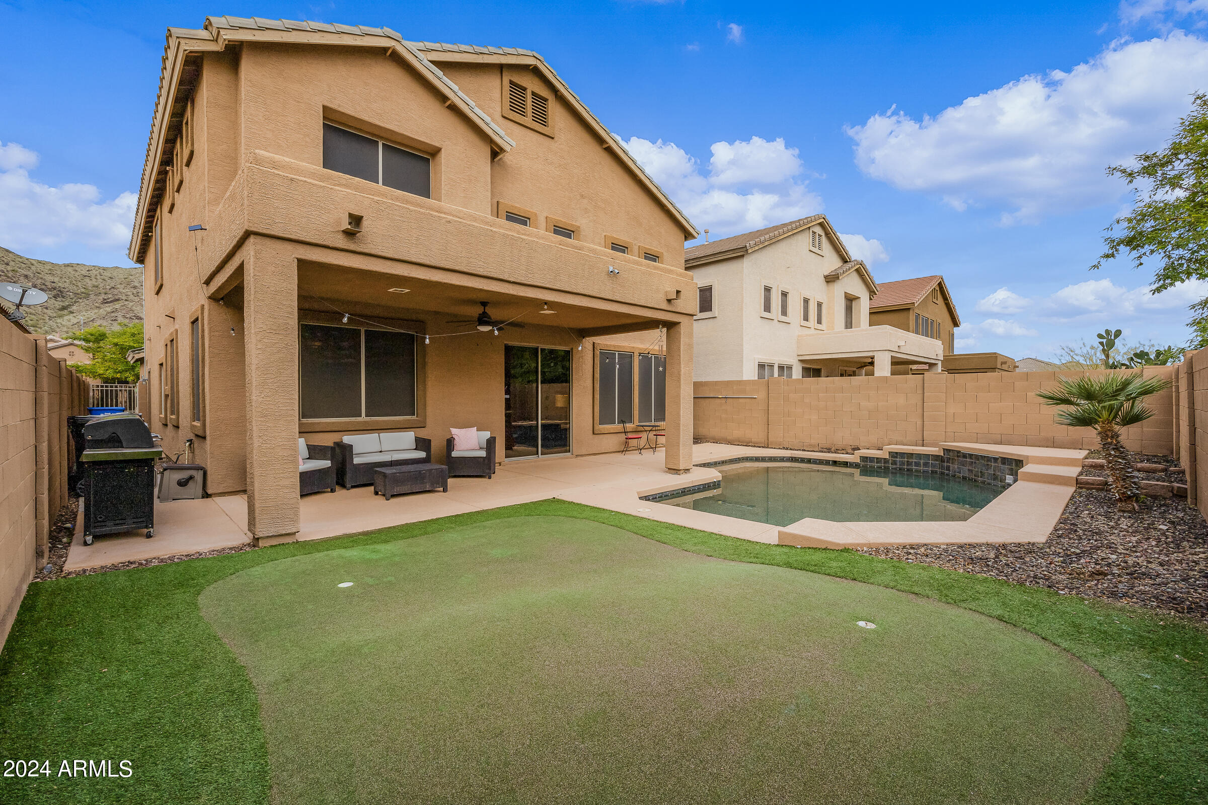 2909 West Silver Fox Way Phoenix, AZ 85045 - Photo 31 of 34 a view of a white house with a big yard and large tree