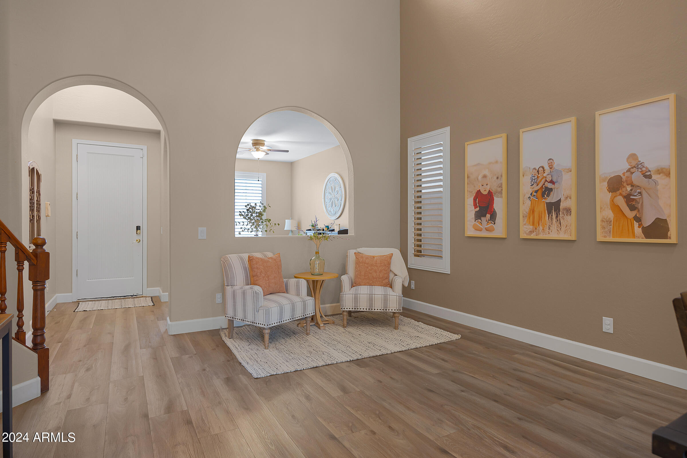 2909 West Silver Fox Way Phoenix, AZ 85045 - Photo 5 of 34 a living room with furniture a large window and wooden floor