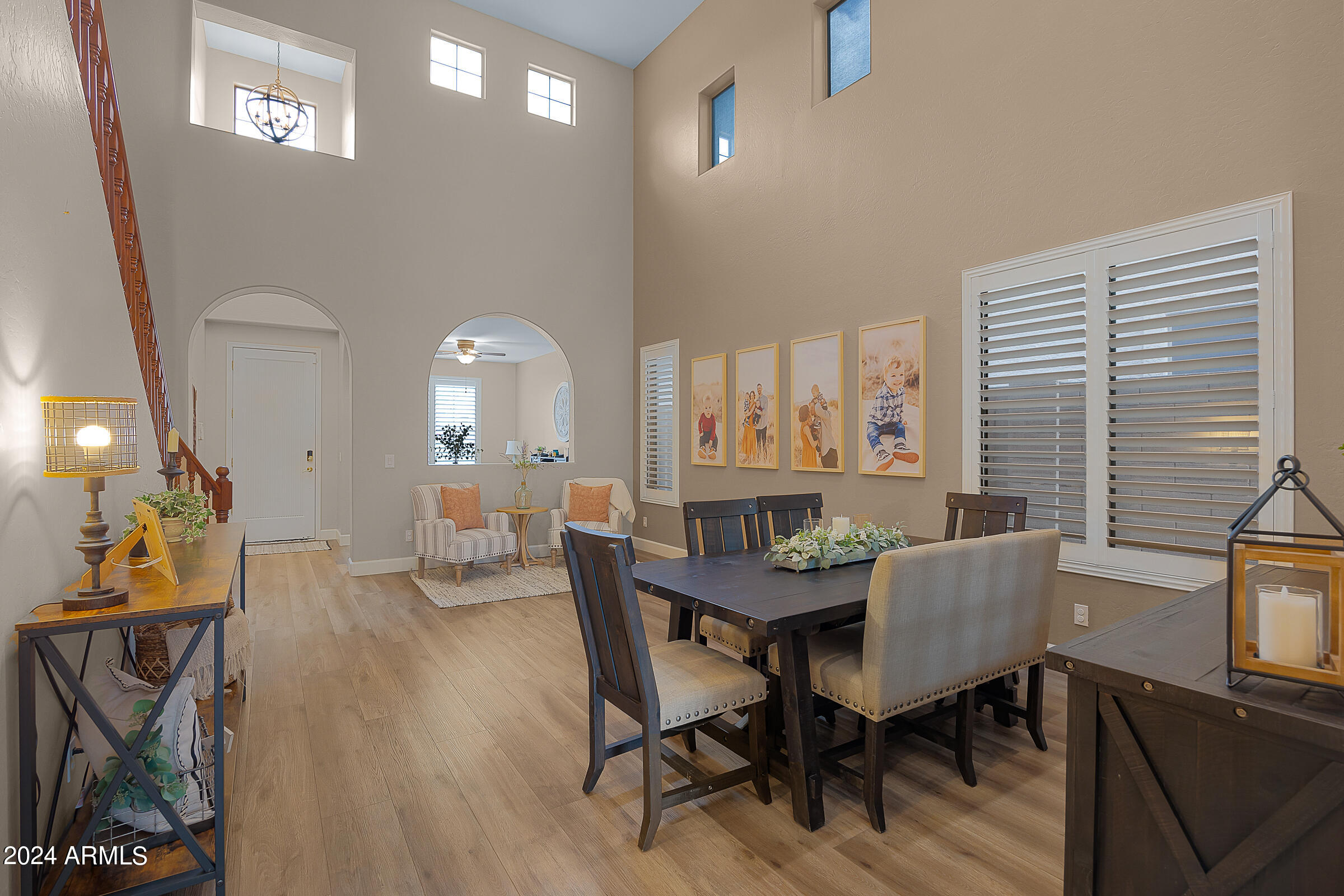 2909 West Silver Fox Way Phoenix, AZ 85045 - Photo 7 of 34 a view of a a dining room with furniture window and wooden floor