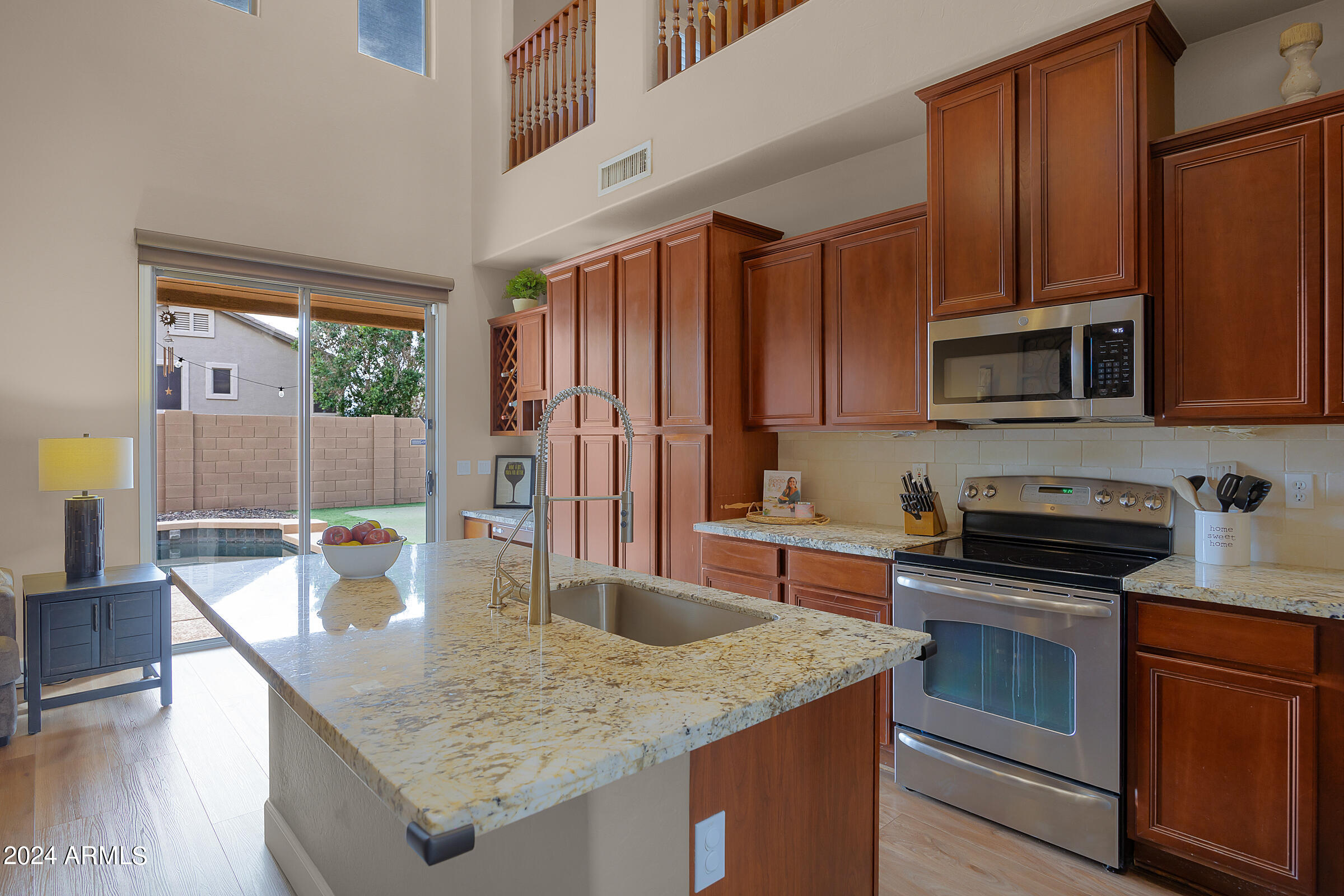 2909 West Silver Fox Way Phoenix, AZ 85045 - Photo 8 of 34 a kitchen with stainless steel appliances granite countertop a stove microwave and cabinets