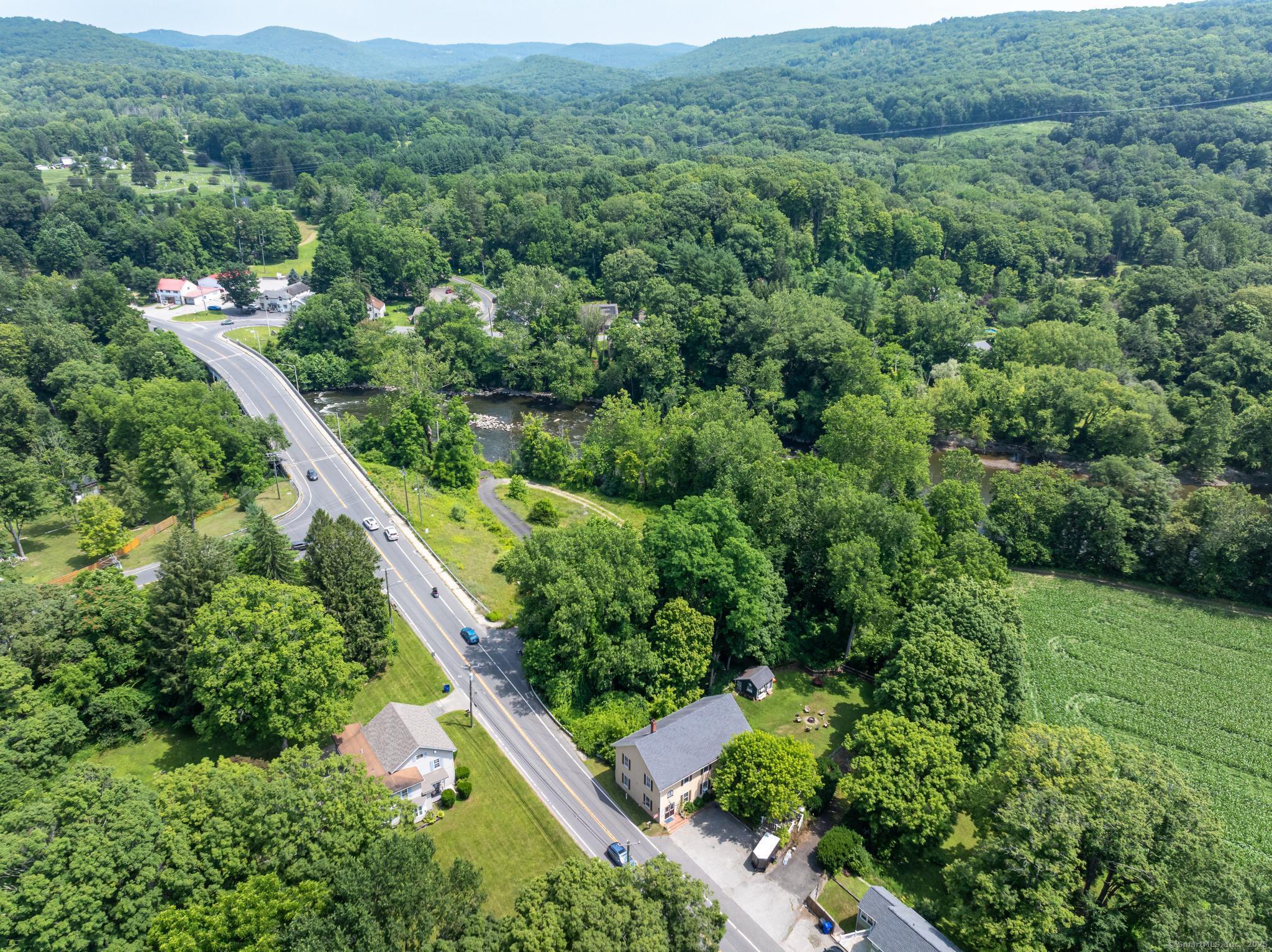 696 Kent Road New Milford, CT 06755 - Photo 22 of 28 an aerial view of green landscape with trees houses and mountain view