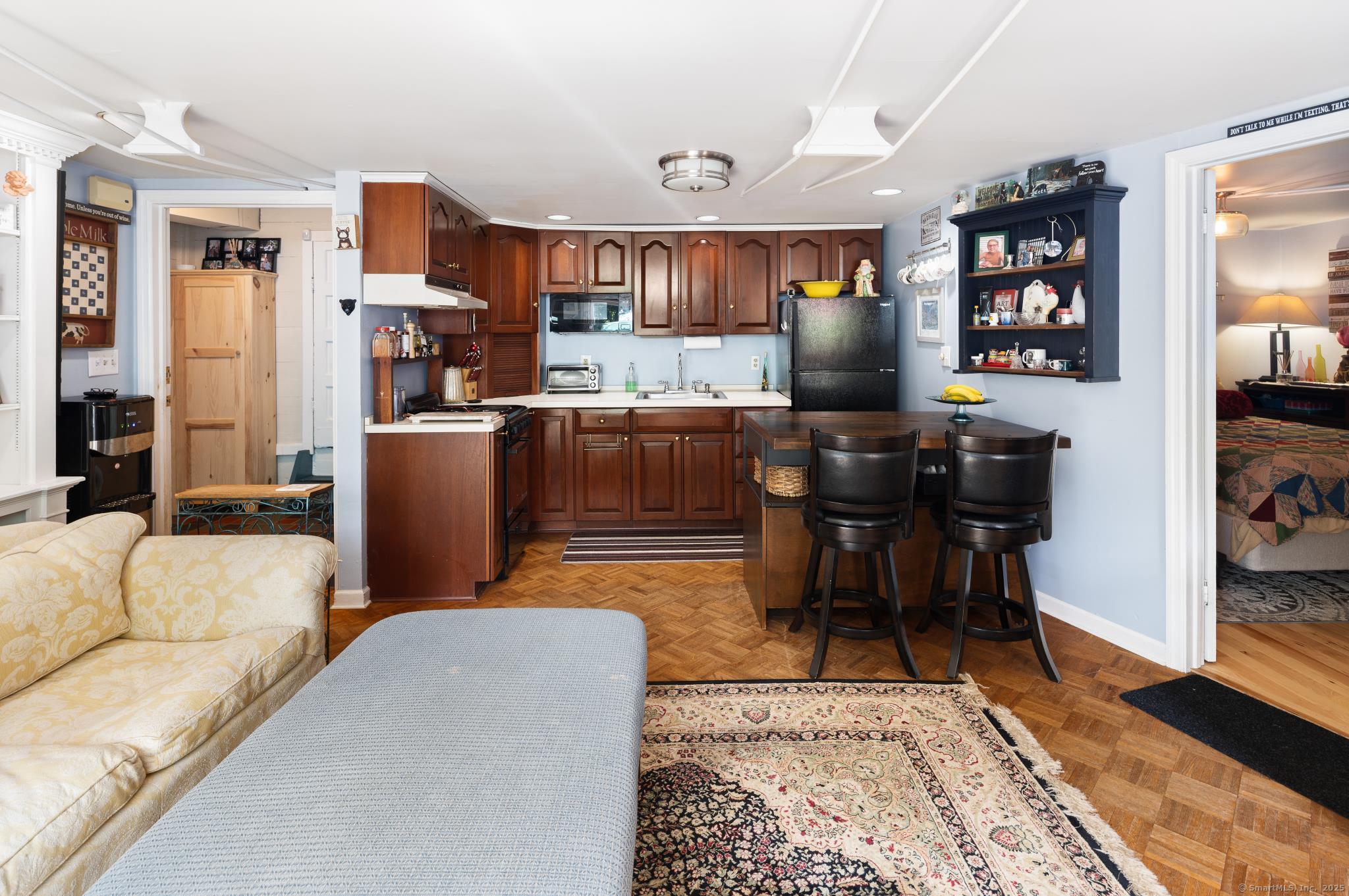 696 Kent Road New Milford, CT 06755 - Photo 10 of 28 a living room with furniture a rug and a table
