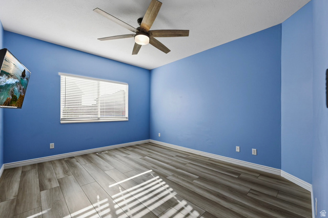 989 South Cinnamon Ridge Drive Provo, UT 84606 - Photo 16 of 52 Room featuring wood-finish flooring, a ceiling fan with integrated lighting, and a window with horizontal blinds