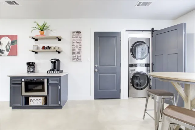 a view of a storage and utility room with washer and dryer