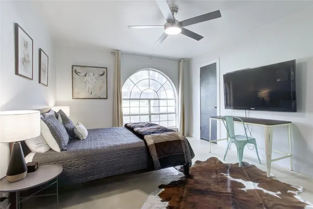 a bedroom with a bed and a flat screen tv