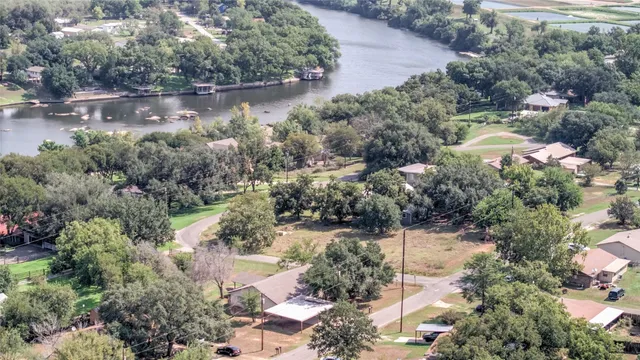 an aerial view of residential house with outdoor space and lake view