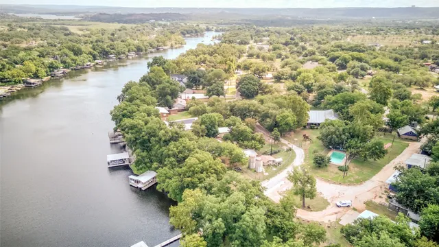an aerial view of residential building with outdoor space and lake view
