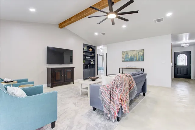 a living room with furniture and a flat screen tv