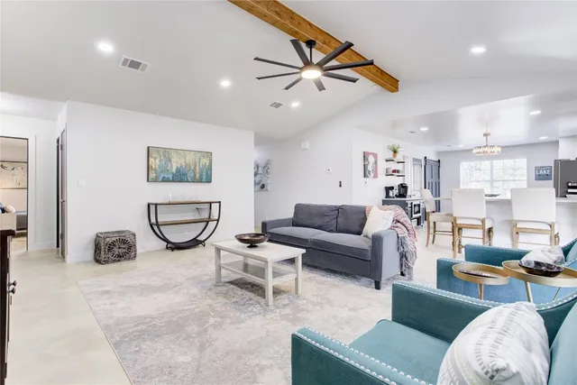 a living room with furniture a rug and a flat screen tv