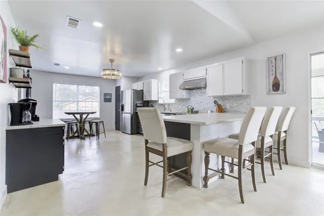 a view of kitchen with microwave and cabinets