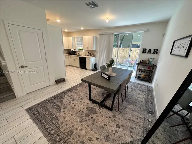 a open kitchen with stainless steel appliances granite countertop a stove refrigerator and cabinets