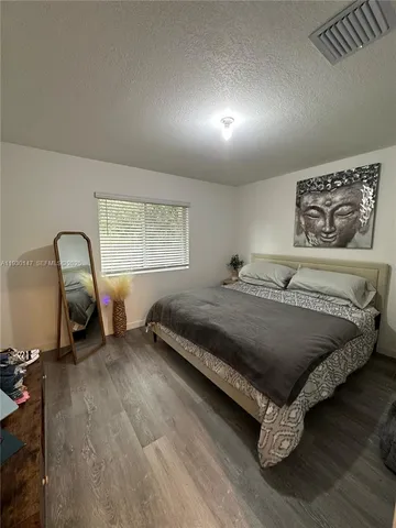 a bed sitting in a room next to a window