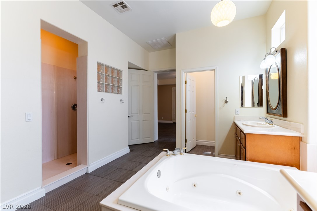3334 Garden Shower Place Las Vegas, NV 89135 - Photo 19 of 32 A spacious bathroom layout features a large soaking tub and tile floors.