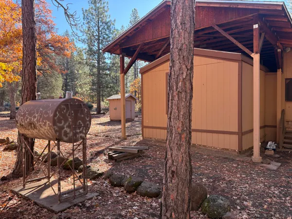 a dining room with stainless steel appliances granite countertop furniture and a large window