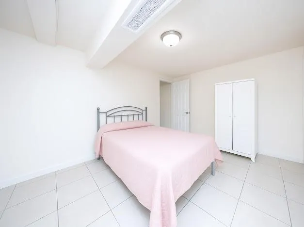 a bedroom with two beds and a window