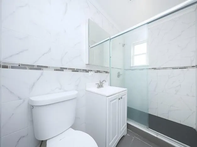 a bathroom with a toilet sink and shower