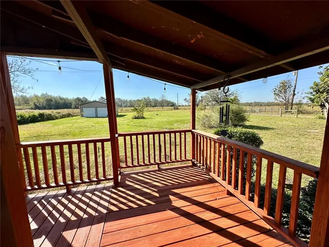 a view of a porch with wooden floor in outdoor space