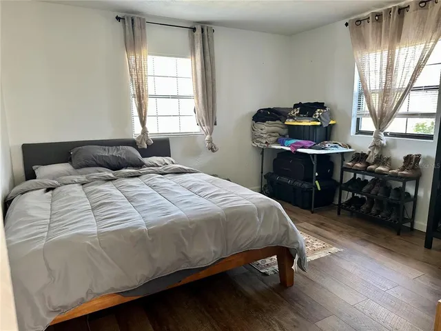 a bedroom with a bed and a window