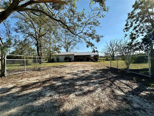 a view of a yard with wooden fence