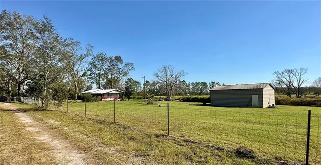 a house with green field in front of it