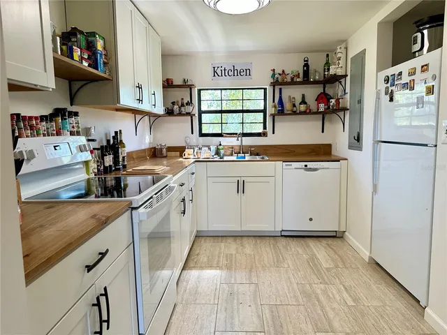 a kitchen with a sink stove and cabinets