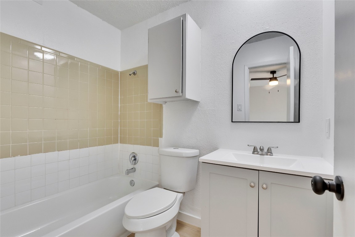 2314 Greenfield Parkway, Unit 108 Austin, TX 78741 - Photo 11 of 23 a bathroom with a toilet sink and mirror