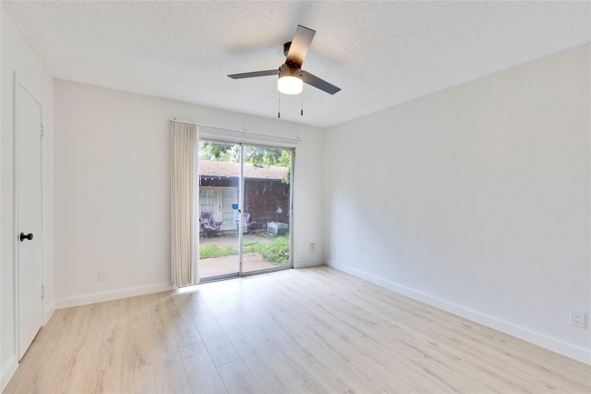 2314 Greenfield Parkway, Unit 108 Austin, TX 78741 - Photo 2 of 23 wooden floor in an empty room with a window