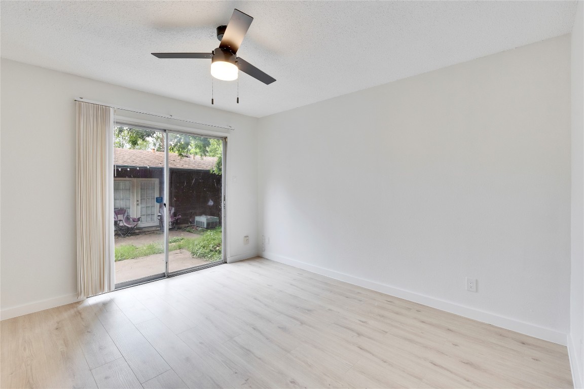 2314 Greenfield Parkway, Unit 108 Austin, TX 78741 - Photo 3 of 23 wooden floor in an empty room with a window