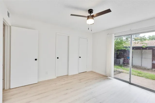 a view of a livingroom with a ceiling fan and window