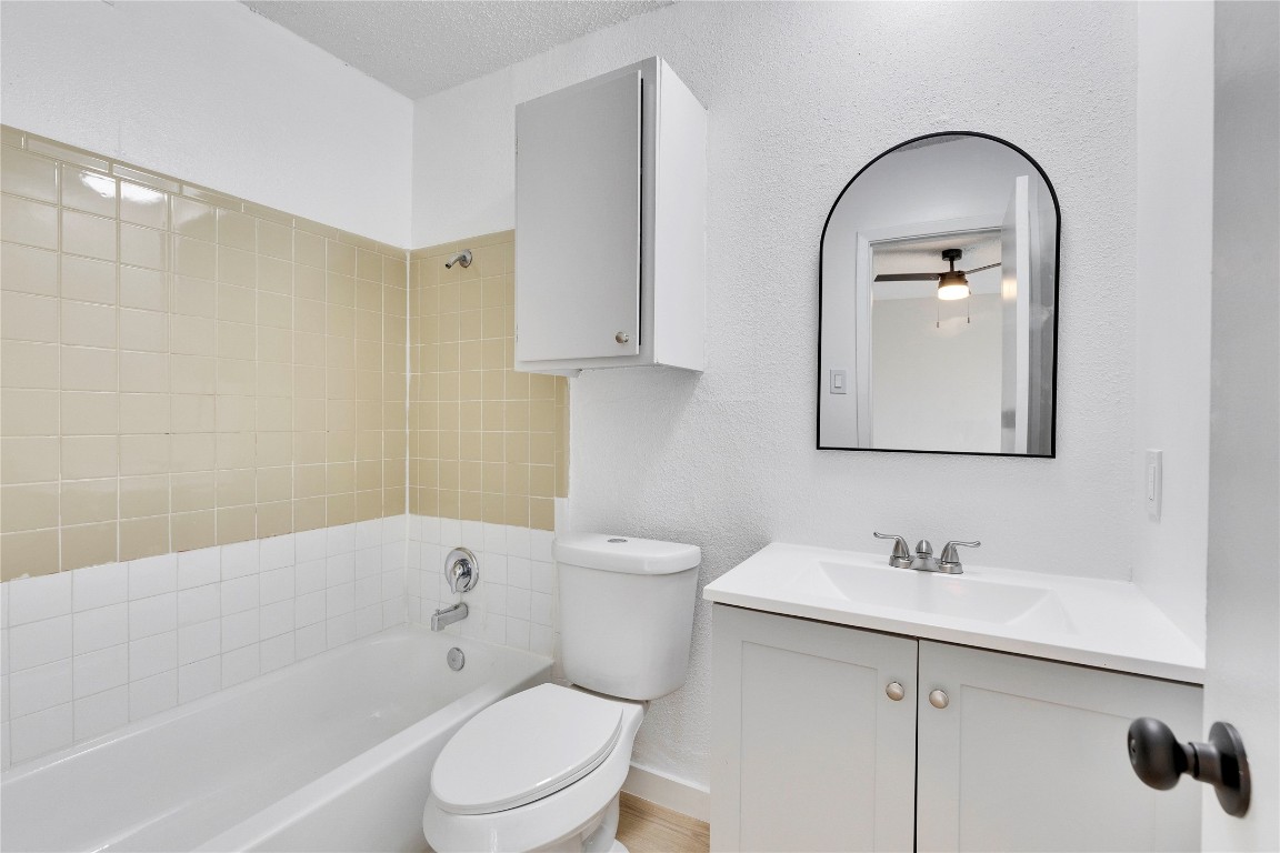 2314 Greenfield Parkway, Unit 108 Austin, TX 78741 - Photo 8 of 23 a bathroom with a sink toilet and shower