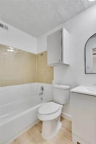 a bathroom with a toilet a sink and bathtub
