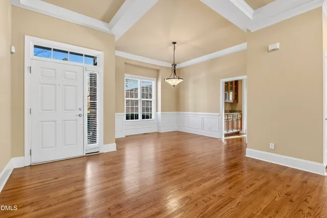 a view of a livingroom with wooden floor and a fireplace
