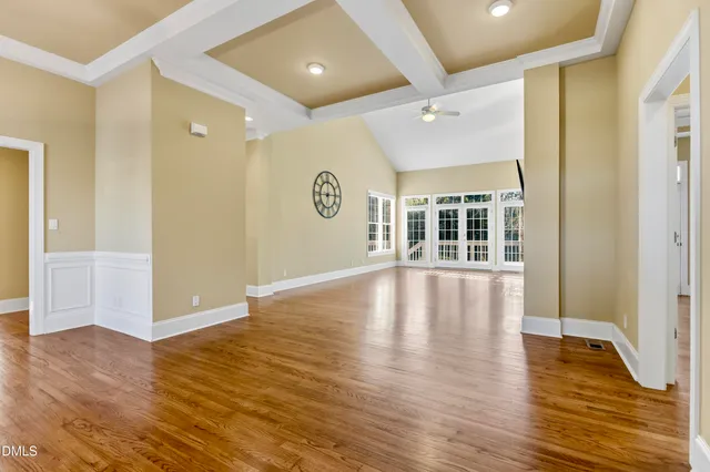 a kitchen with granite countertop a refrigerator and wooden cabinets