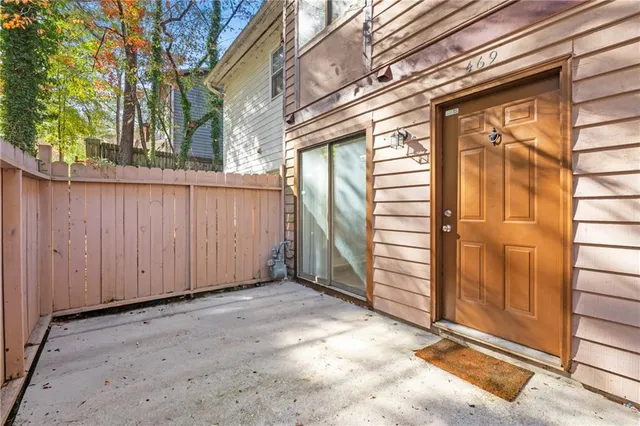 a view of a house with a door and wooden walls