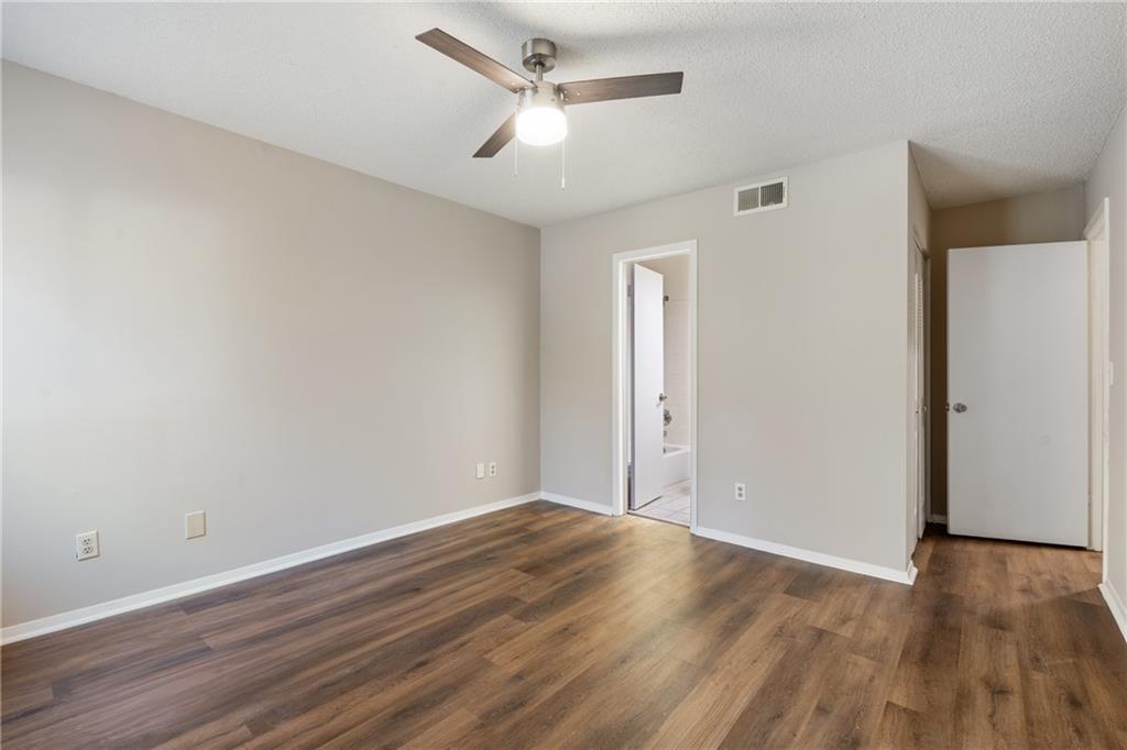 469 Granite Ridge Place Atlanta, GA 30350 - Photo 13 of 18 an empty room with wooden floor and windows