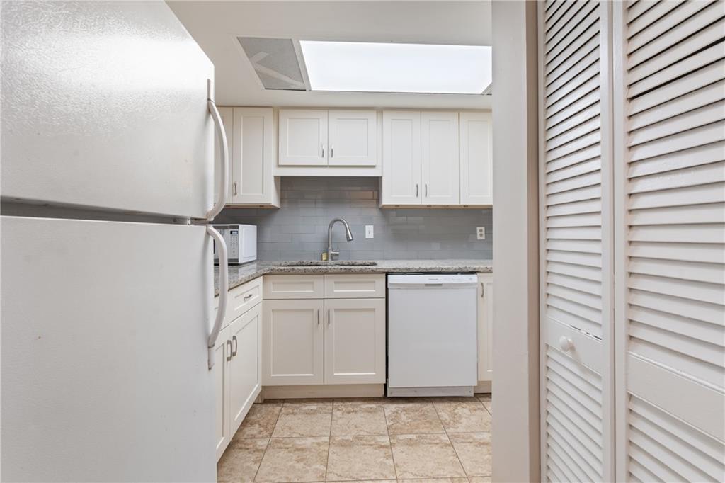 469 Granite Ridge Place Atlanta, GA 30350 - Photo 3 of 18 a kitchen with white cabinets and white appliances