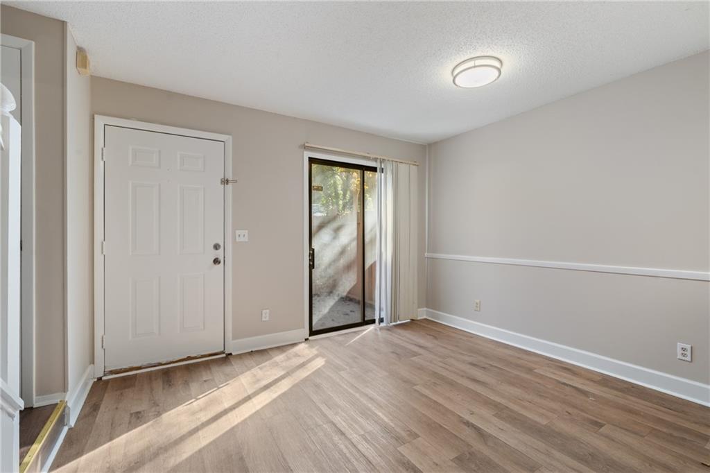 469 Granite Ridge Place Atlanta, GA 30350 - Photo 6 of 18 an empty room with wooden floor and windows