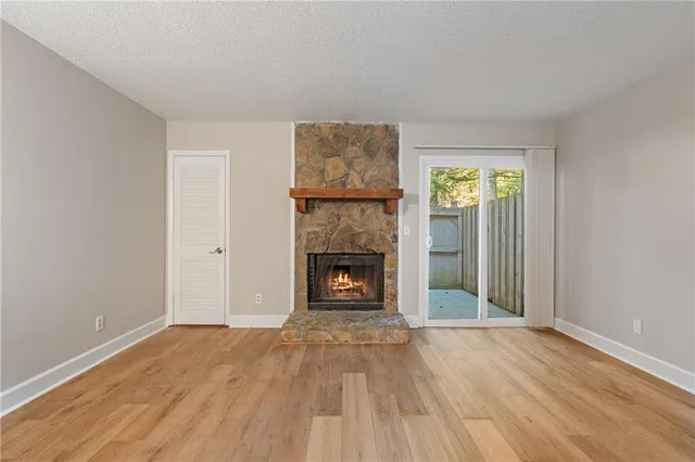 a view of a livingroom with a fireplace a fireplace and wooden floor