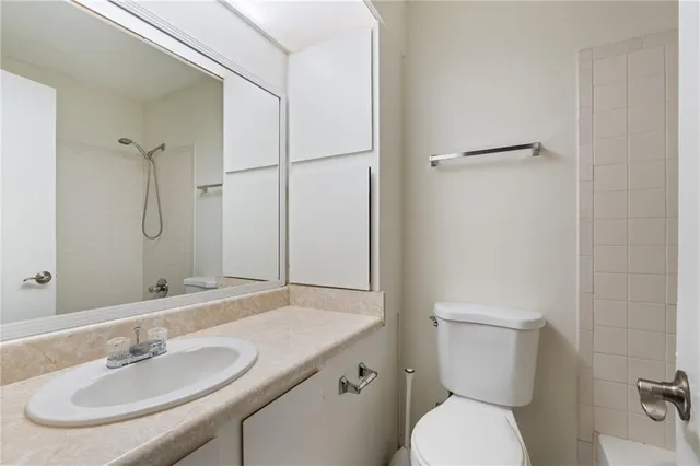 a bathroom with a sink toilet and a mirror